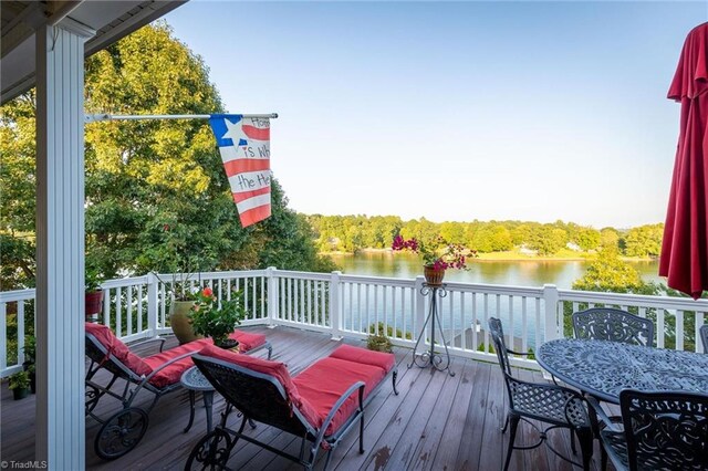 wooden deck featuring a water view