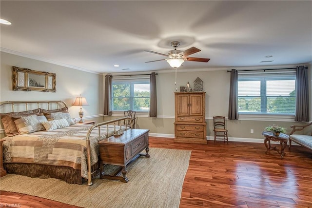 bedroom with ornamental molding, dark hardwood / wood-style floors, and ceiling fan