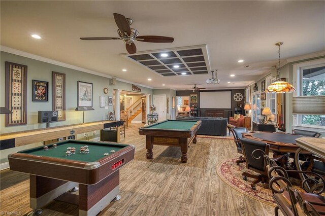 rec room with ceiling fan, pool table, ornamental molding, and light wood-type flooring