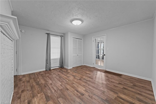 unfurnished bedroom with dark wood-type flooring, a closet, and a textured ceiling