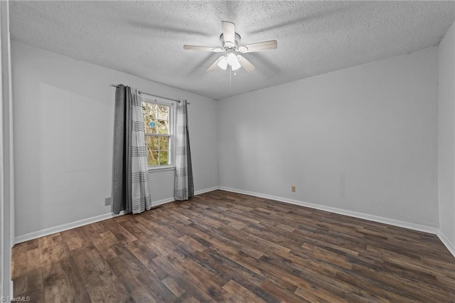 spare room featuring dark hardwood / wood-style flooring, a textured ceiling, and ceiling fan