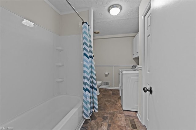 bathroom with a textured ceiling, shower / bath combination with curtain, and toilet