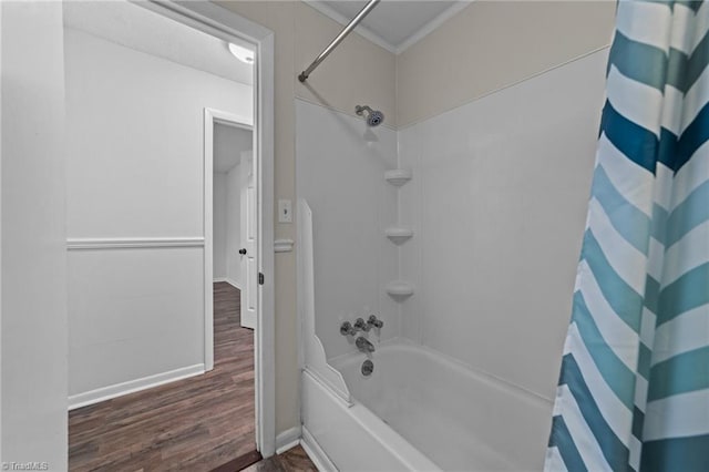 bathroom with hardwood / wood-style flooring and shower / bath combination with curtain