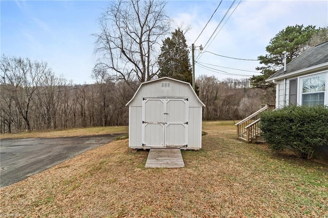 view of outdoor structure featuring a lawn