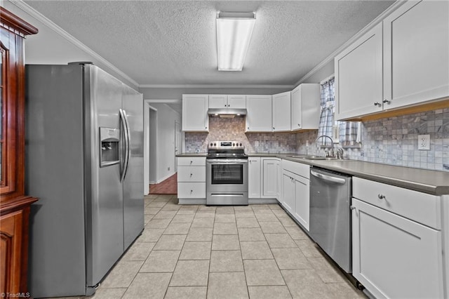 kitchen with stainless steel appliances, ornamental molding, sink, and white cabinets