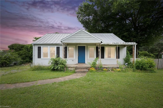 view of front of house with a yard and covered porch