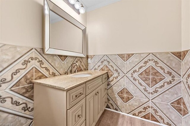 649 W Main St, Franklinville, NC 27248 - bathroom with vanity, tile walls, and wood finished floors