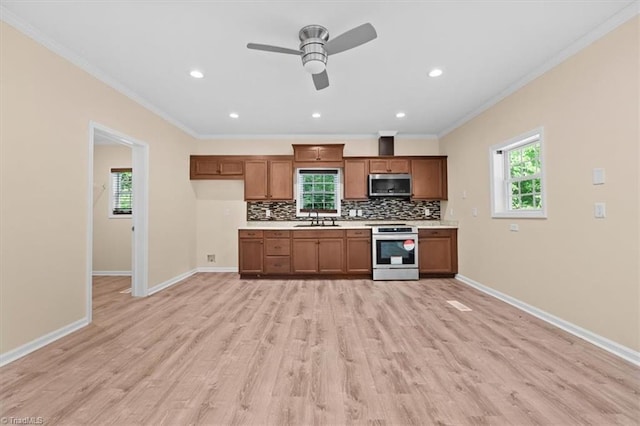 649 W Main St, Franklinville, NC 27248 - kitchen featuring stainless steel microwave, stove, a sink, light countertops, and decorative backsplash