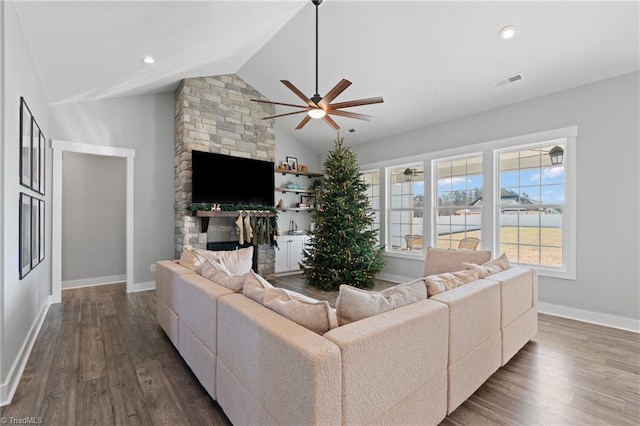 living room featuring hardwood / wood-style floors, ceiling fan, a fireplace, and high vaulted ceiling