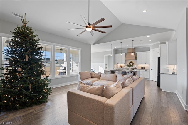 living room with ceiling fan, sink, dark wood-type flooring, and high vaulted ceiling