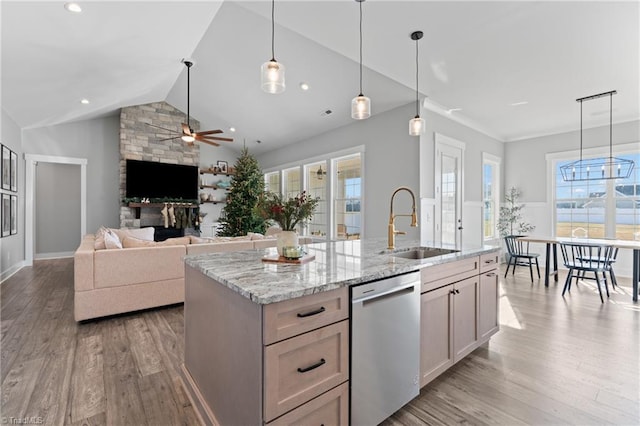 kitchen featuring dishwasher, plenty of natural light, lofted ceiling, and light wood-type flooring