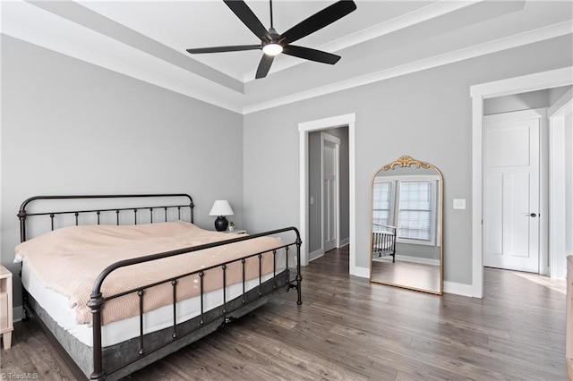 bedroom with ceiling fan, crown molding, and dark wood-type flooring