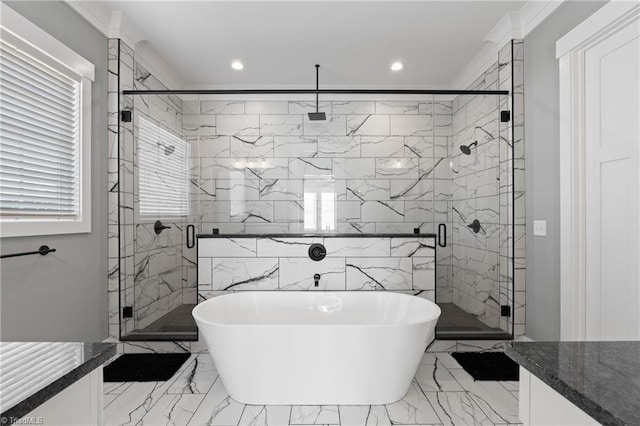 bathroom with separate shower and tub, crown molding, vanity, and tile walls