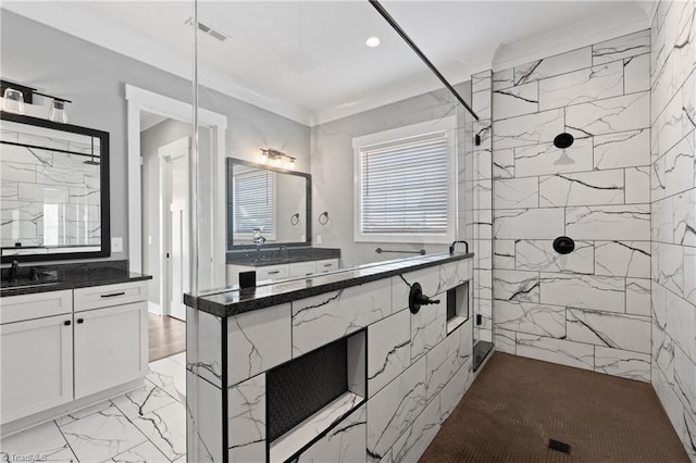 bathroom with tiled shower and vanity