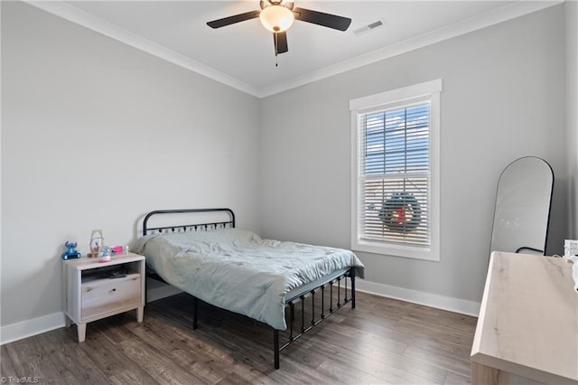 bedroom with ceiling fan, dark hardwood / wood-style flooring, and crown molding