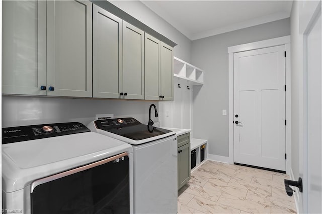 clothes washing area with washer and clothes dryer, sink, cabinets, and crown molding