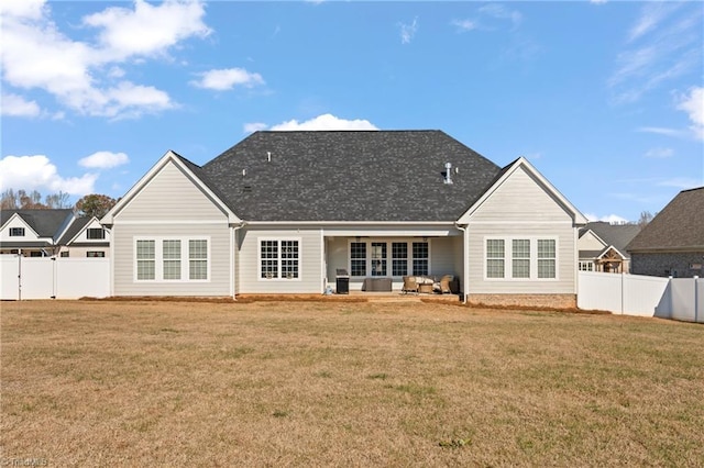 rear view of property featuring outdoor lounge area and a yard