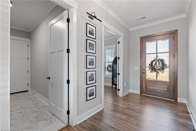 foyer with light hardwood / wood-style floors and crown molding