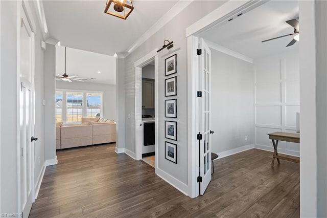 corridor with dark hardwood / wood-style flooring and crown molding