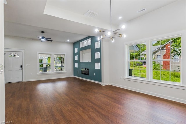 1924 E 25th St, Winston-Salem, NC 27105 - unfurnished living room featuring plenty of natural light, wood-type flooring, baseboards, a chandelier, and recessed lighting