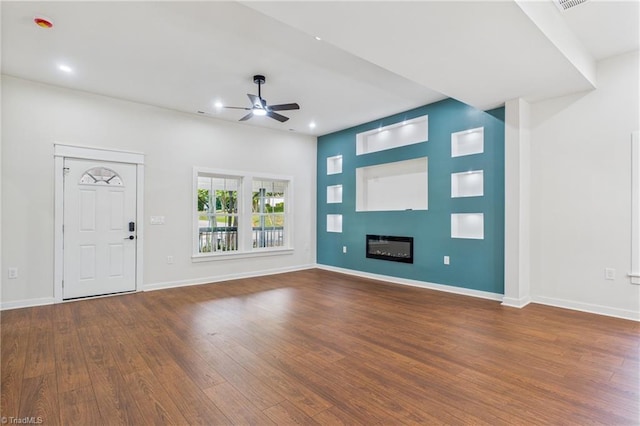 1924 E 25th St, Winston-Salem, NC 27105 - entrance foyer with ceiling fan, wood finished floors, a glass covered fireplace, recessed lighting, and baseboards