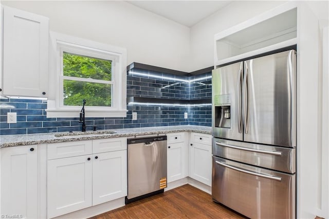 1924 E 25th St, Winston-Salem, NC 27105 - kitchen with appliances with stainless steel finishes, a sink, white cabinetry, and decorative backsplash