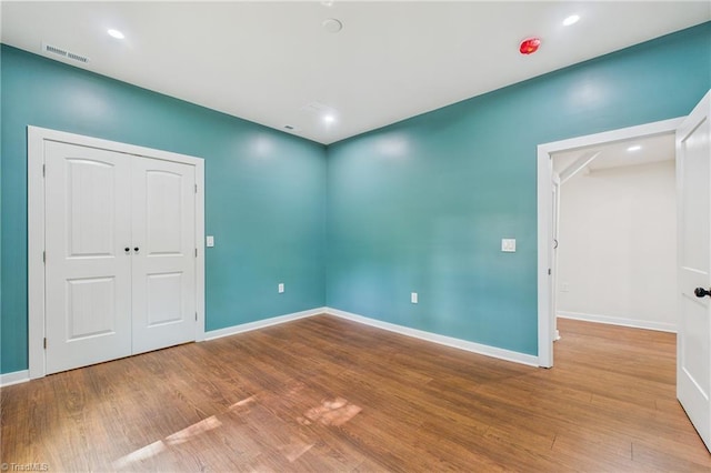 1924 E 25th St, Winston-Salem, NC 27105 - unfurnished bedroom with wood finished floors, baseboards, and a closet