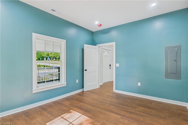 1924 E 25th St, Winston-Salem, NC 27105 - spare room featuring electric panel, baseboards, and wood finished floors