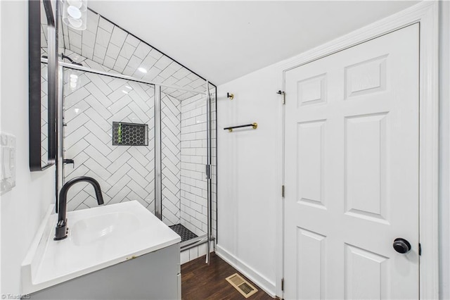 1924 E 25th St, Winston-Salem, NC 27105 - bathroom featuring a stall shower, vanity, wood finished floors, and baseboards