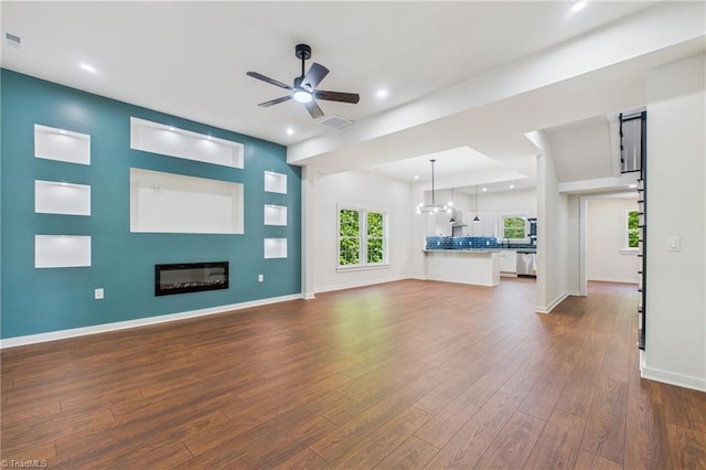 1924 E 25th St, Winston-Salem, NC 27105 - unfurnished living room with dark wood-type flooring, ceiling fan, a glass covered fireplace, baseboards, and recessed lighting