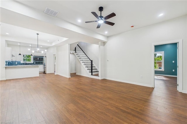 1924 E 25th St, Winston-Salem, NC 27105 - unfurnished living room featuring wood finished floors, recessed lighting, ceiling fan, and plenty of natural light