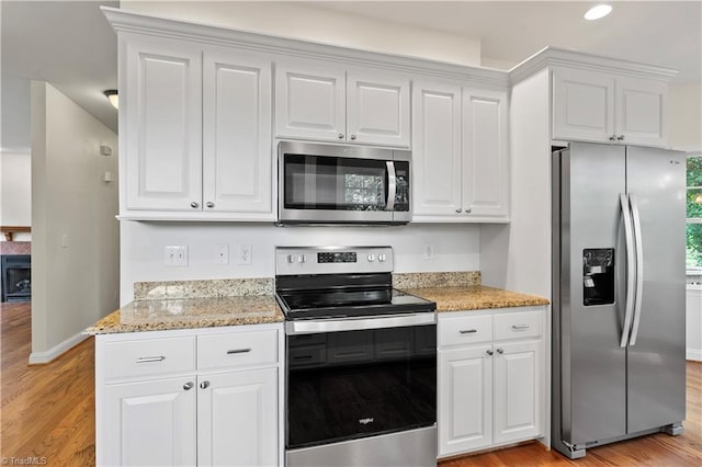 833 E Country Club Rd, Mount Airy, NC 27030 - kitchen featuring appliances with stainless steel finishes, light wood finished floors, baseboards, white cabinets, and recessed lighting