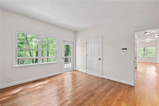 833 E Country Club Rd, Mount Airy, NC 27030 - unfurnished bedroom featuring access to exterior, light wood-style flooring, and baseboards