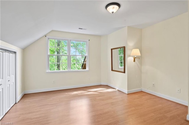 833 E Country Club Rd, Mount Airy, NC 27030 - unfurnished bedroom featuring light wood-type flooring, baseboards, and lofted ceiling