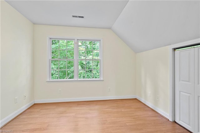 833 E Country Club Rd, Mount Airy, NC 27030 - additional living space featuring light wood finished floors, plenty of natural light, vaulted ceiling, and baseboards
