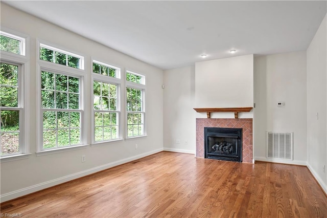 833 E Country Club Rd, Mount Airy, NC 27030 - unfurnished living room with wood finished floors, baseboards, and a fireplace