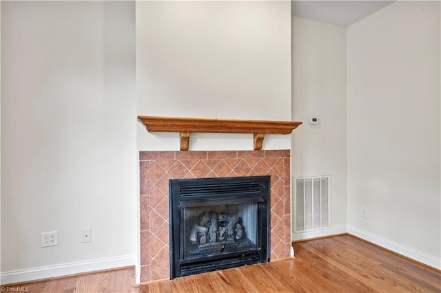 833 E Country Club Rd, Mount Airy, NC 27030 - detailed view of wood finished floors, baseboards, and a tile fireplace