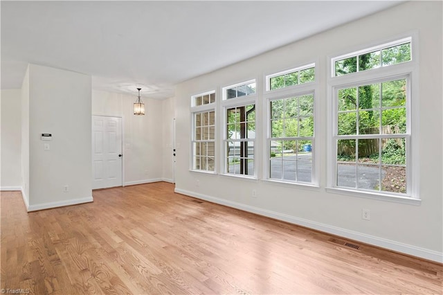 833 E Country Club Rd, Mount Airy, NC 27030 - empty room featuring baseboards, light wood-type flooring, and healthy amount of natural light