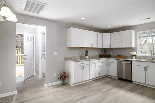5425 Davis Rd, Walkertown, NC 27105 - kitchen with stainless steel dishwasher, light wood-style floors, recessed lighting, white cabinets, and light stone countertops