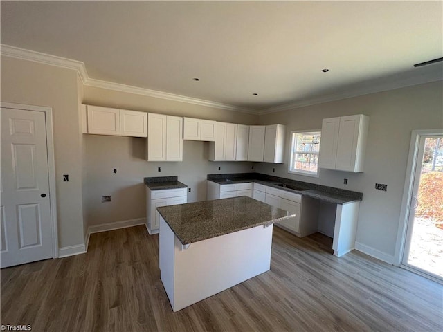 kitchen featuring a wealth of natural light, white cabinetry, and a kitchen island