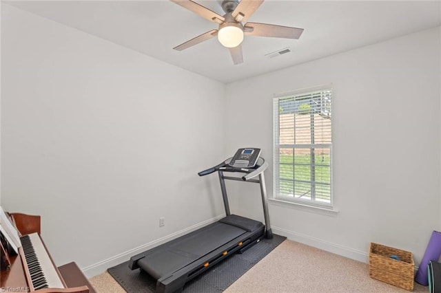 exercise area featuring baseboards, a ceiling fan, carpet flooring, and visible vents