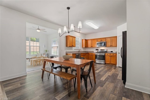 dining room with baseboards and dark wood-style flooring