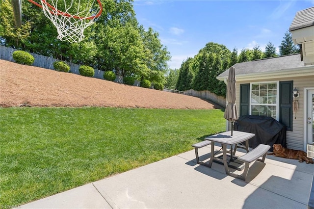 view of patio / terrace with grilling area and a fenced backyard