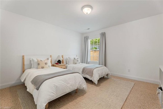 carpeted bedroom featuring baseboards