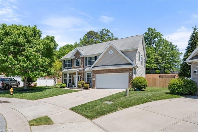 view of front of property featuring concrete driveway, fence, a front yard, and a garage