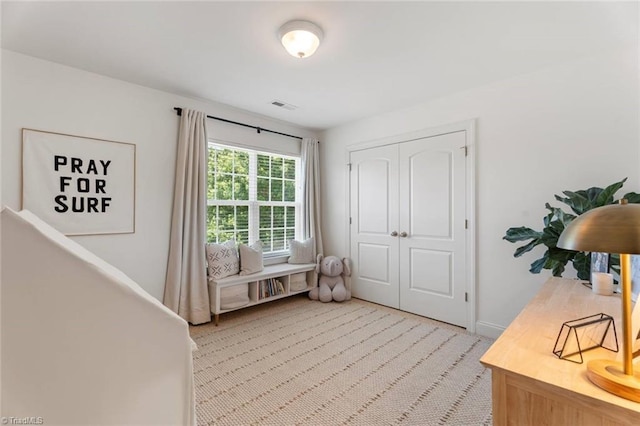 interior space with visible vents, baseboards, and light colored carpet