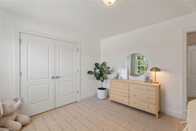 bedroom featuring baseboards and light carpet