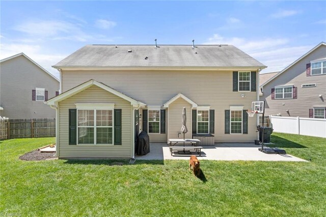 back of property featuring a yard, a patio, and a fenced backyard