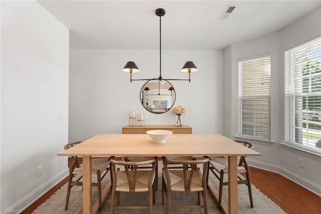dining area with baseboards, dark wood-style floors, and a wealth of natural light