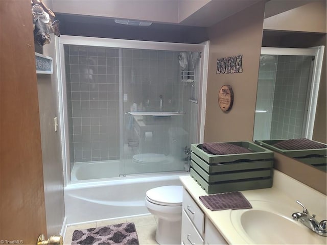 full bathroom featuring tile patterned flooring, vanity, toilet, and enclosed tub / shower combo